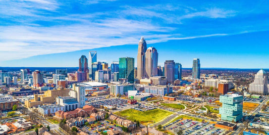 Aerial view of the Charlotte, North Carolina skyline featuring modern skyscrapers and vibrant cityscape.