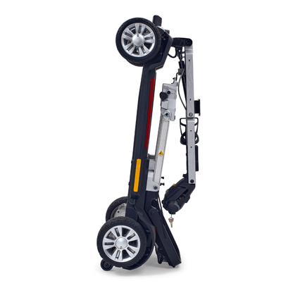 Buzzaround CarryOn GB120 folding scooter in upright position for easy transport, features lightweight design and portability.