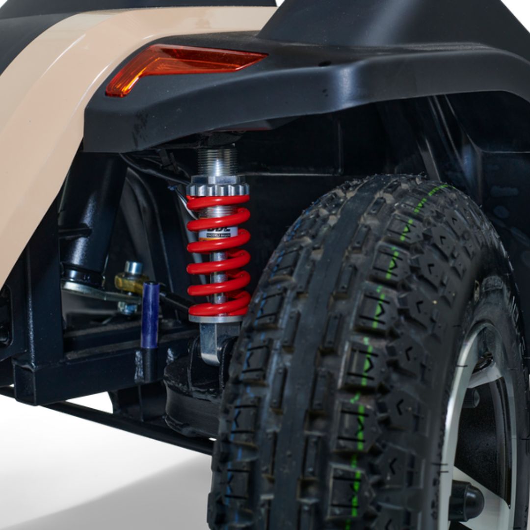 Close-up of Eagle 4-Wheel Heavy Duty Mobility Scooter's rear suspension and rugged tire, showcasing durability and performance.